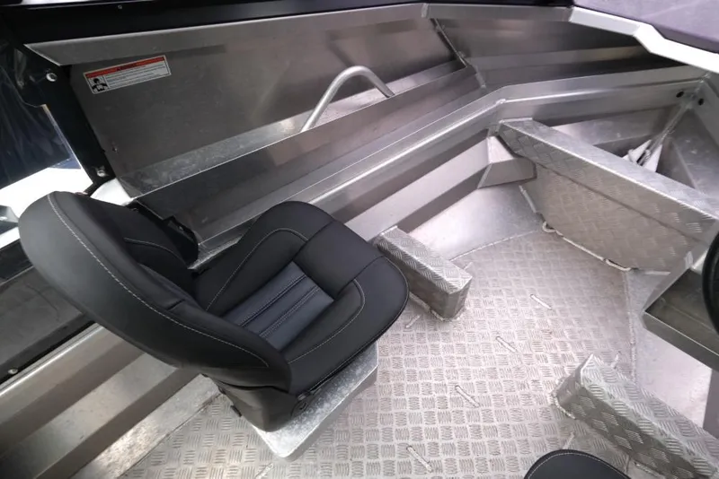 Slide: The Image of 2019 Stabicraft 1550 Fisher interior with black seat and aluminum flooring. - 9