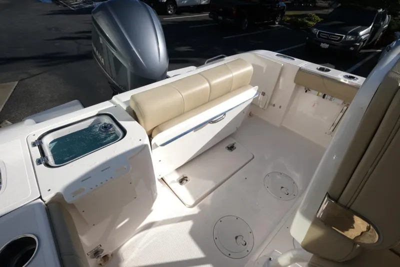Slide: The Image of 2017 Pursuit C 238 Center Console boat interior with seating and storage compartments. - 12