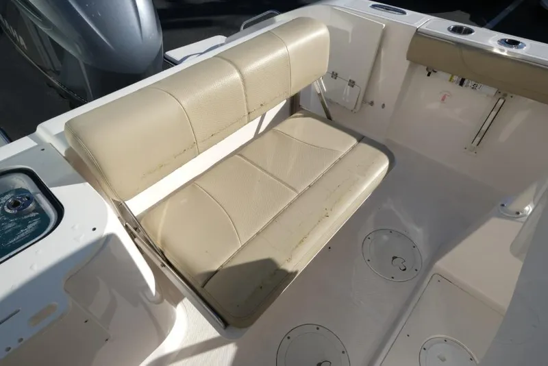 Slide: The Image of 2017 Pursuit C 238 Center Console boat with beige seating and storage compartments. - 13