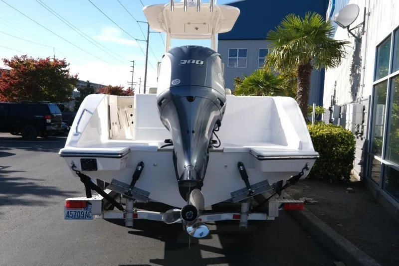 Slide: The Image of 2017 Pursuit C 238 Center Console boat with powerful outboard motor, parked outdoors. - 5