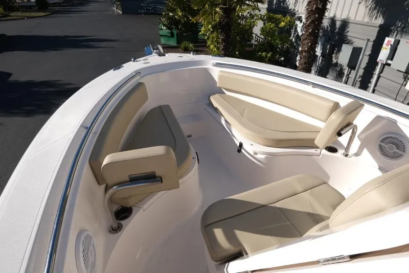 Slide: The Image of 2017 Pursuit C 238 Center Console boat with beige seating and sleek design. - 9