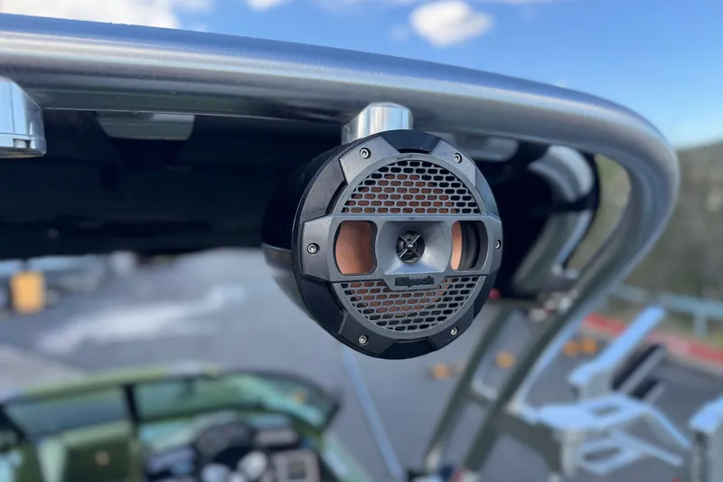 Slide: The Image of 2023 MasterCraft NXT22 boat speaker on a metal frame, clear sky background. - 12