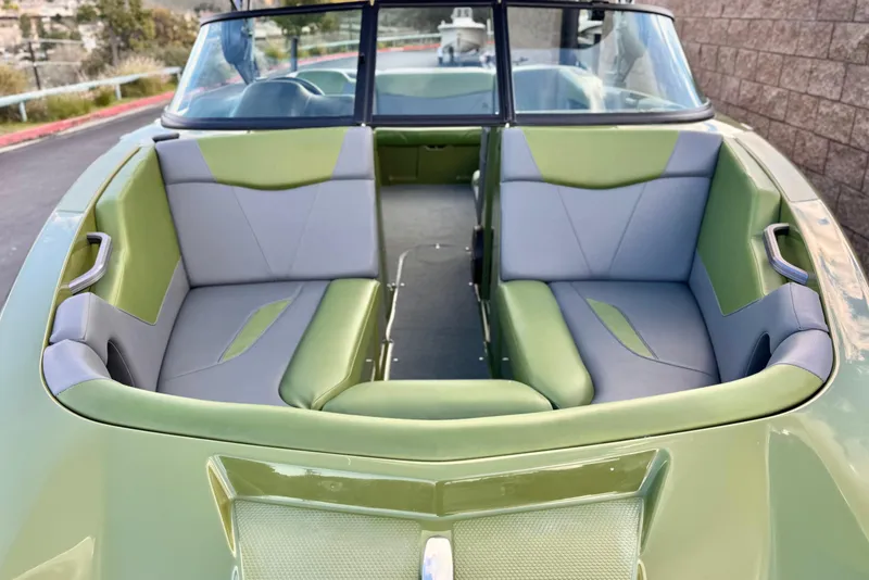 Slide: The Image of 2023 MasterCraft NXT22 boat interior with green and gray seating. - 13