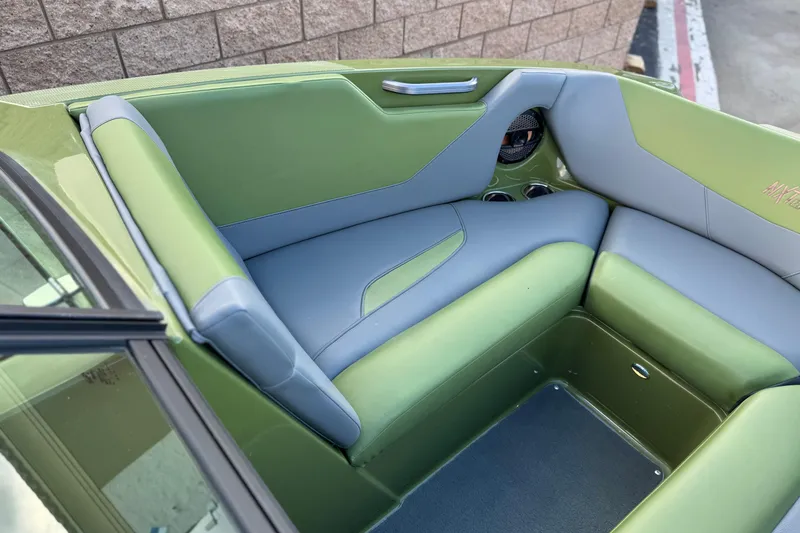 Slide: The Image of 2023 MasterCraft NXT22 boat interior with green and gray seating. - 15