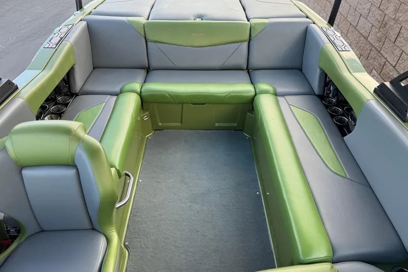 Slide: The Image of 2023 MasterCraft NXT22 boat interior with green and gray seating arrangement. - 18