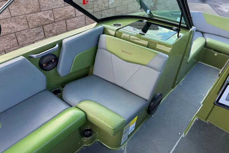 Slide: The Image of 2023 MasterCraft NXT22 boat interior with green and gray seating. - 24