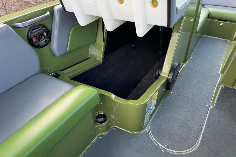 Slide: The Image of 2023 MasterCraft NXT22 boat interior with open storage compartment and green seating. - 25