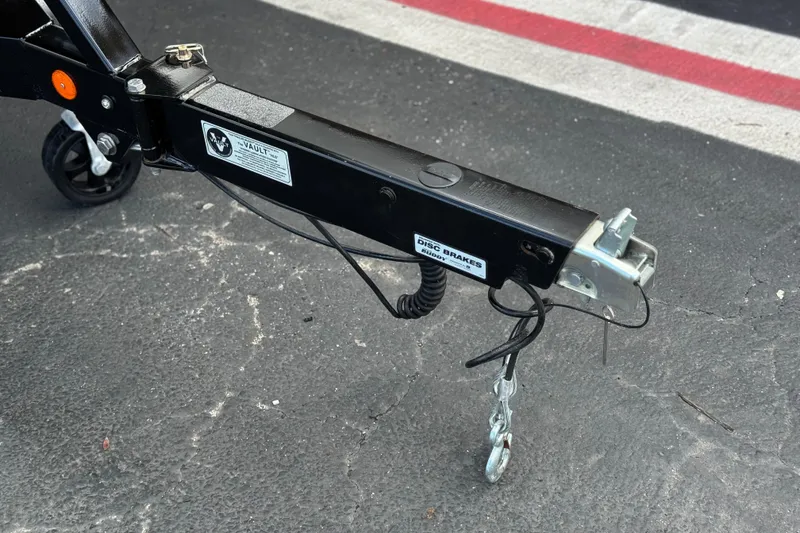 Slide: The Image of Trailer hitch of 2023 MasterCraft NXT22 boat on asphalt surface. - 34