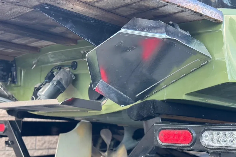 Slide: The Image of 2023 MasterCraft NXT22 boat underside with metal components and trailer lights. - 8