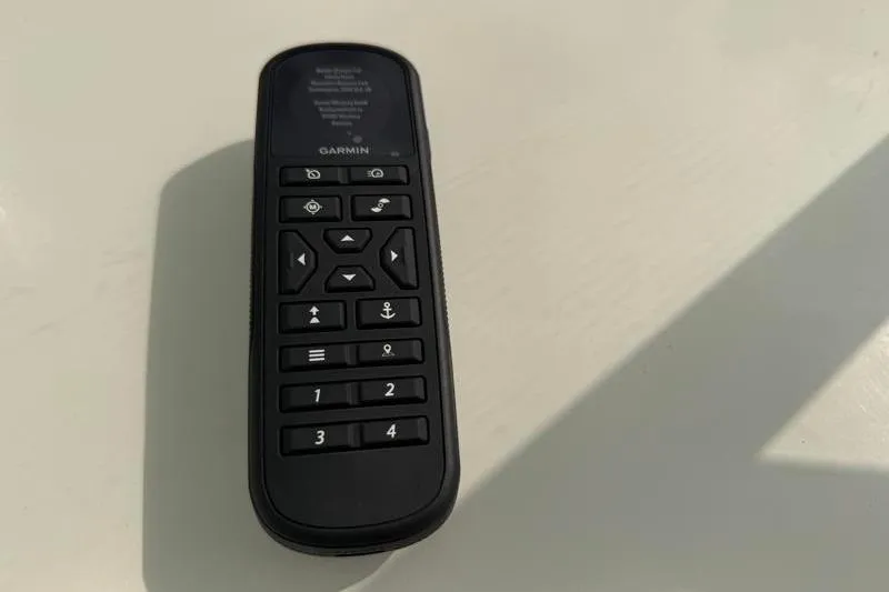 Slide: The Image of Garmin remote control on a Key West 210 Bay Reef 2024 boat. - 10