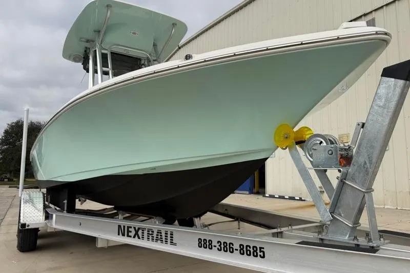 Slide: The Image of 2024 Key West 210 Bay Reef boat on trailer, displayed outdoors. - 12