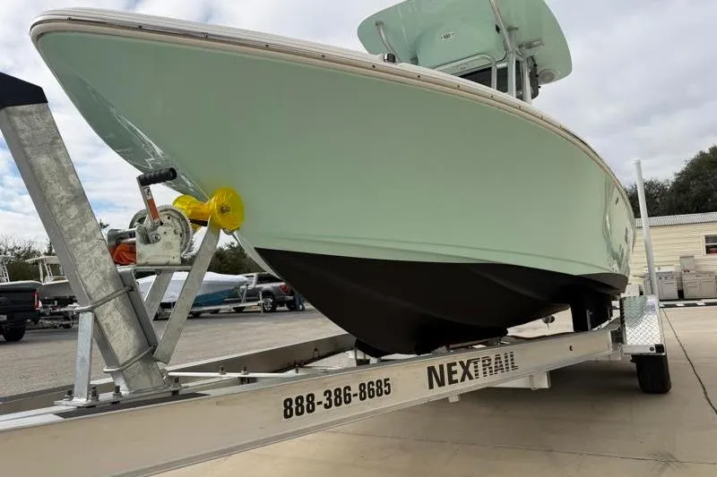 Slide: The Image of 2024 Key West 210 Bay Reef boat on trailer, displayed outdoors. - 13