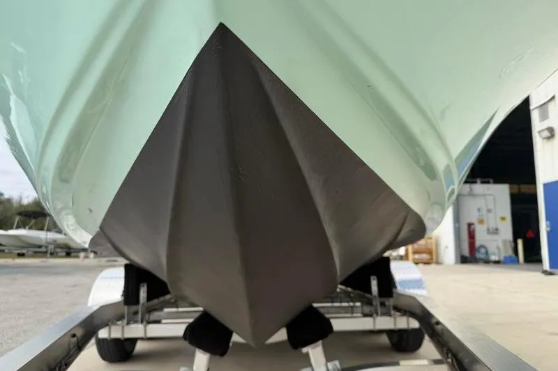 Slide: The Image of 2024 Key West 210 Bay Reef boat hull on trailer, close-up view. - 14