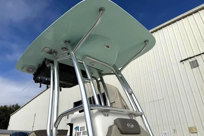 Slide: The Image of 2024 Key West 210 Bay Reef boat with T-top against blue sky. - 19