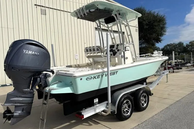 Slide: The Image of 2024 Key West 210 Bay Reef boat on trailer with Yamaha outboard motor. - 2