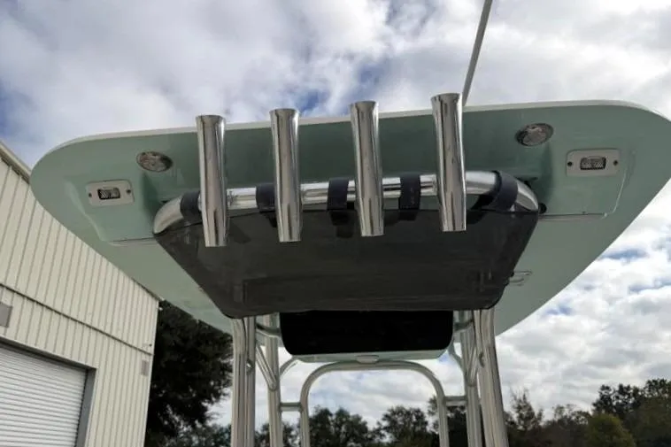 Slide: The Image of 2024 Key West 210 Bay Reef boat T-top with rod holders, under a cloudy sky. - 20