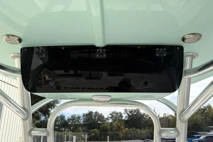 Slide: The Image of 2024 Key West 210 Bay Reef boat T-top with rod holders and electronics box. - 25