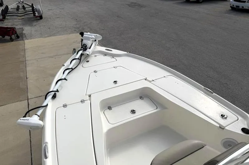 Slide: The Image of 2024 Key West 210 Bay Reef boat deck with storage compartments and trolling motor. - 27