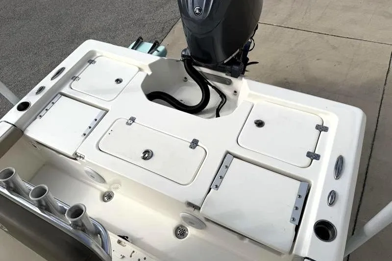 Slide: The Image of 2024 Key West 210 Bay Reef boat deck with storage compartments and motor. - 28