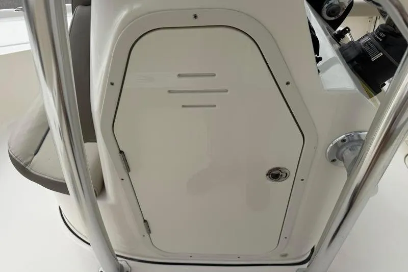 Slide: The Image of 2024 Key West 210 Bay Reef console storage door with stainless steel frame. - 30