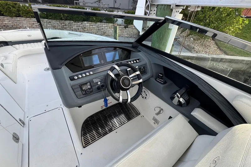Slide: The Image of 2018 Cobalt 30SC boat helm with modern controls and sleek steering wheel. - 20