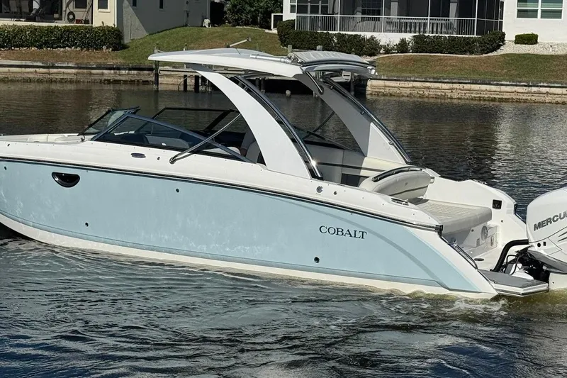Slide: The Image of 2018 Cobalt 30SC boat cruising on a calm waterway, featuring sleek design and modern amenities. - 9