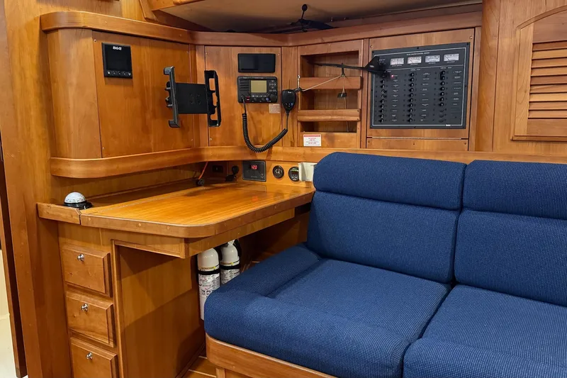 Slide: The Image of Interior of 2003 Sabre 362 sailboat with navigation station and blue seating. - 10