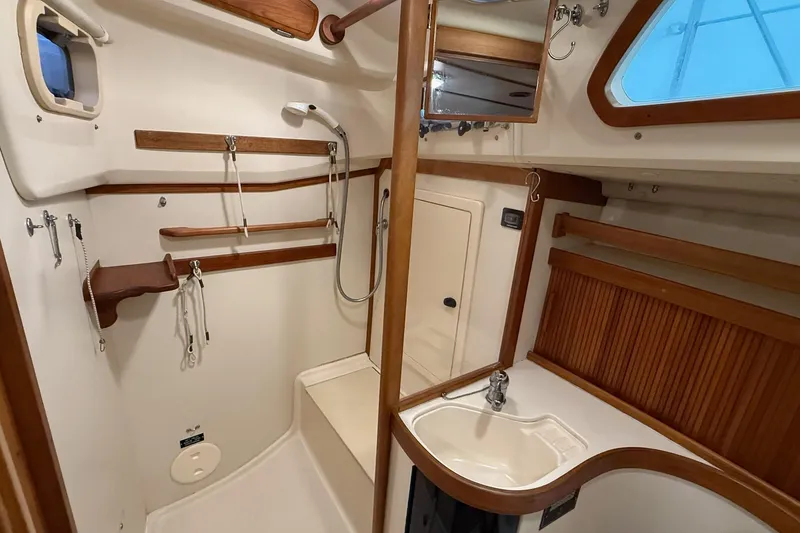 Slide: The Image of 2003 Sabre 362 yacht bathroom with wooden accents and compact sink. - 11