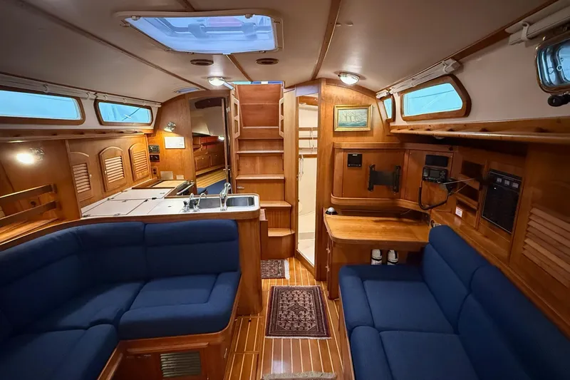 Slide: The Image of Interior of 2003 Sabre 362 sailboat with wooden finish and blue seating. - 13