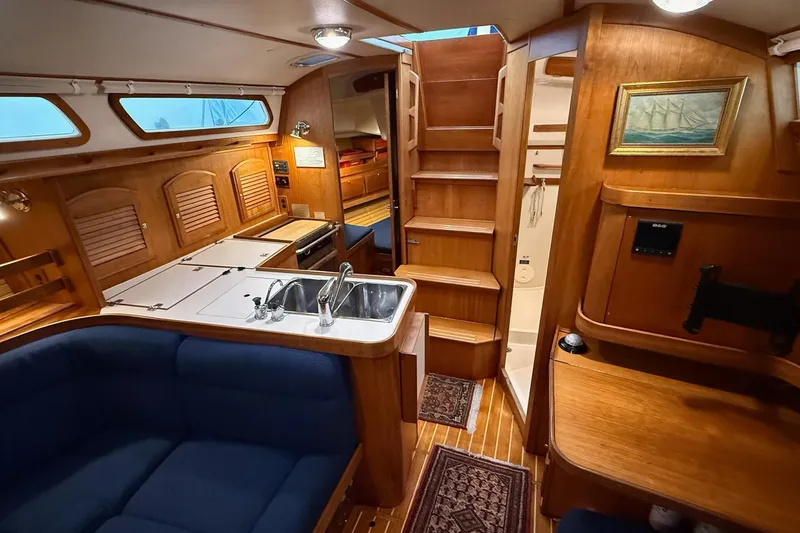 Slide: The Image of Interior of 2003 Sabre 362 sailboat with wooden cabinetry and blue seating. - 14