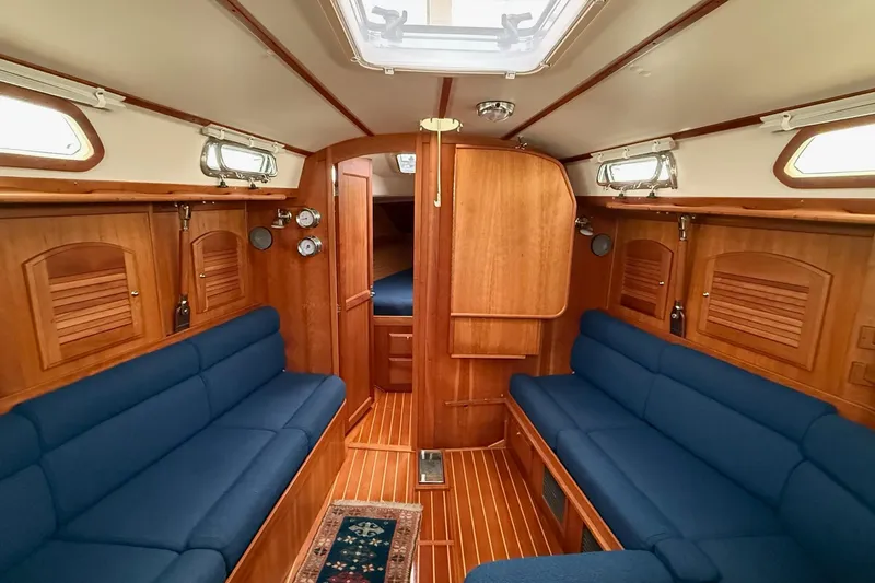 Slide: The Image of Interior of 2003 Sabre 362 sailboat with wooden finish and blue seating. - 15