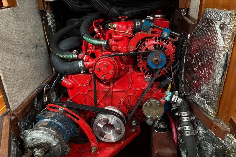 Slide: The Image of Red engine of a 2003 Sabre 362 boat, featuring hoses and belts in a compact space. - 18