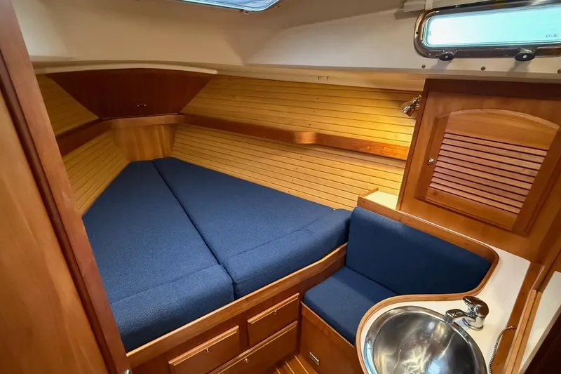 Slide: The Image of Cozy cabin interior of 2003 Sabre 362 sailboat with blue cushions and wooden finish. - 21