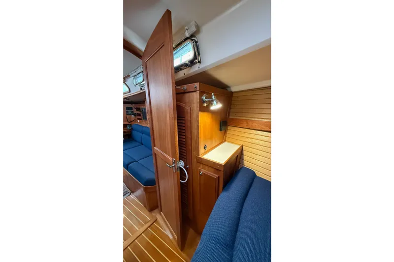 Slide: The Image of Interior of 2003 Sabre 362 sailboat with wooden cabinetry and blue seating. - 22