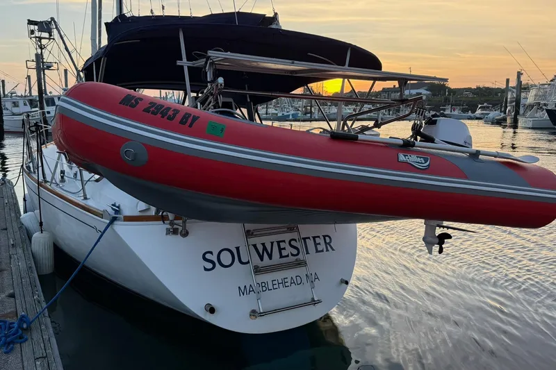 Slide: The Image of 2003 Sabre 362 sailboat "Souwester" docked with red dinghy at sunset. - 25