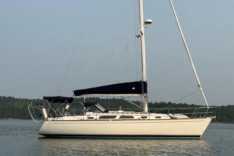 Slide: The Image of 2003 Sabre 362 sailboat on calm water with forested background. - 29