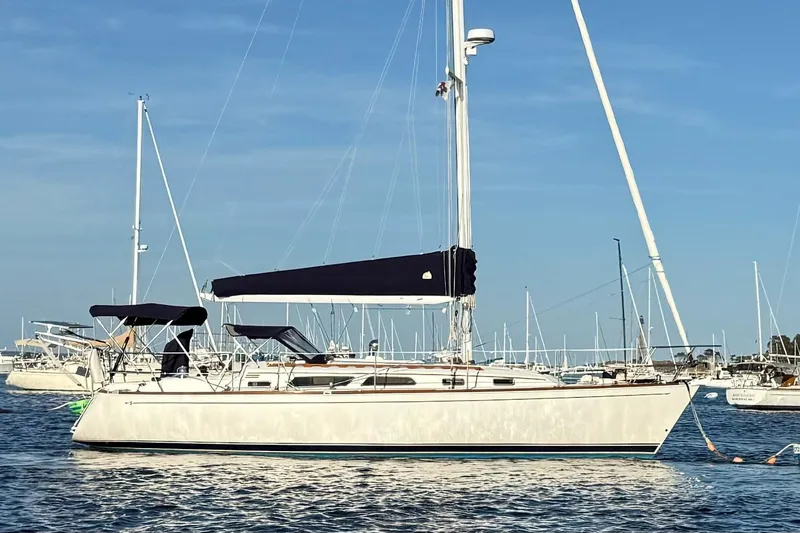 Slide: The Image of 2003 Sabre 362 sailboat anchored in a marina under clear blue skies. - 30