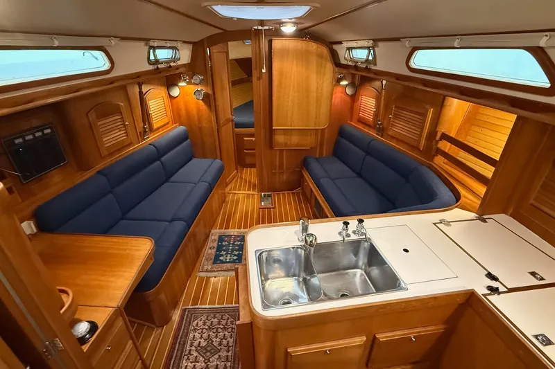 Slide: The Image of Luxurious interior of 2003 Sabre 362 yacht with blue seating and wooden finishes. - 8
