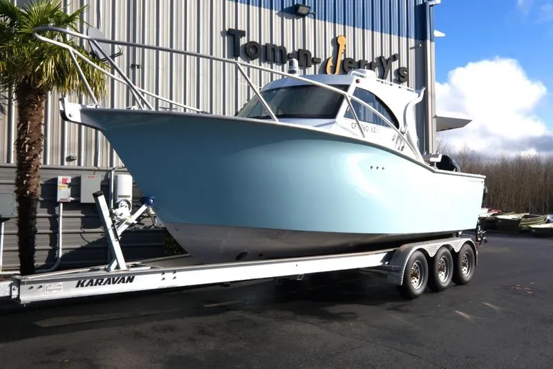 The Image of 2023 Makaira Sportfish 800 boat on trailer outside dealership. - 1