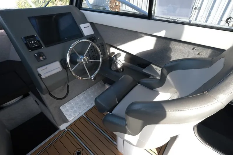 Slide: The Image of 2023 Makaira Sportfish 800 helm with steering wheel and modern controls. - 16