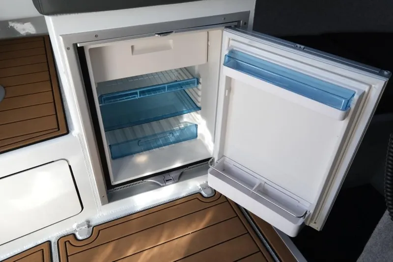 Slide: The Image of Open refrigerator on Makaira Sportfish 800 boat, showcasing interior storage space, 2023 model. - 21