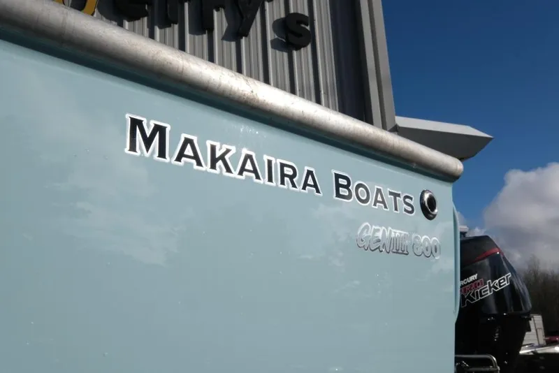 Slide: The Image of Makaira Sportfish 800 boat, 2023 model, with visible branding and Mercury engine. - 8