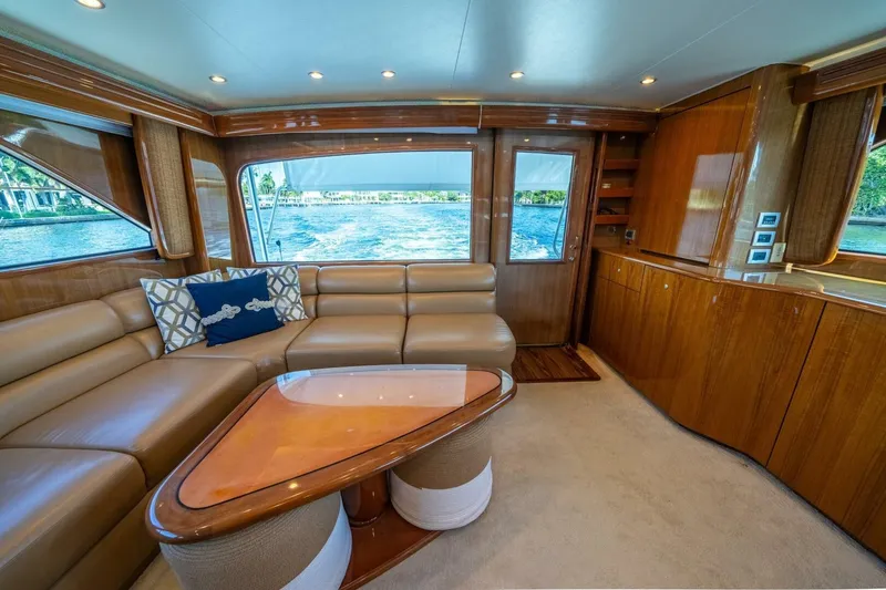 Slide: The Image of Luxurious interior of a 2006 Viking 68 Convertible yacht with leather seating and wooden finishes. - 23