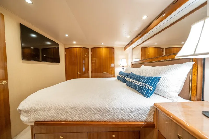 Slide: The Image of Luxurious bedroom interior of 2006 Viking 68 Convertible yacht with elegant wood finishes. - 25