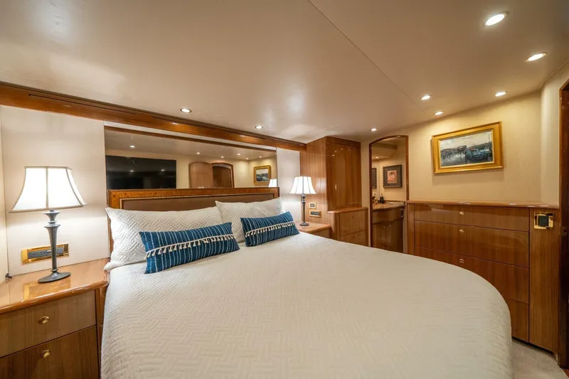Slide: The Image of Luxurious bedroom interior of 2006 Viking 68 Convertible yacht with elegant wood finishes. - 26