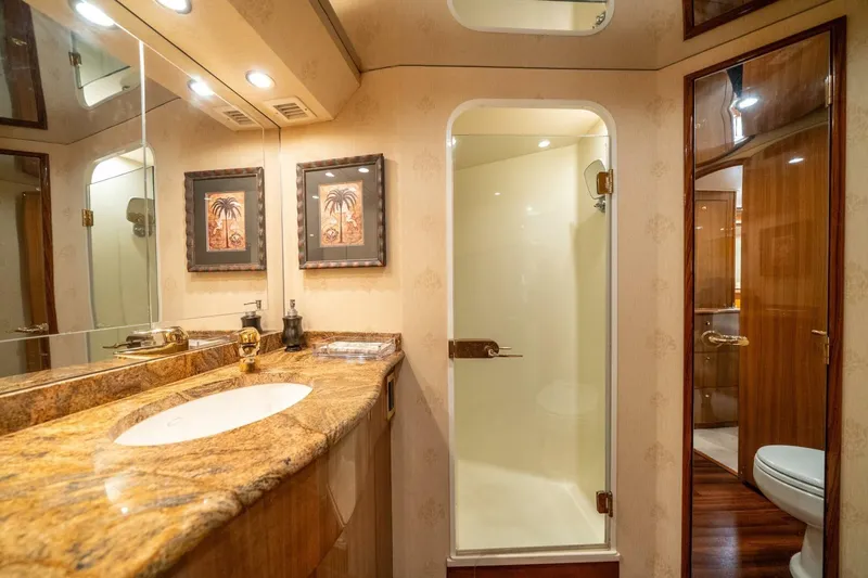 Slide: The Image of Luxurious bathroom in 2006 Viking 68 Convertible yacht with elegant fixtures and wood accents. - 28
