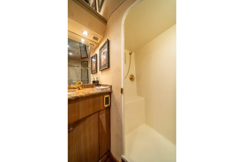 Slide: The Image of Luxurious bathroom in 2006 Viking 68 Convertible yacht with elegant fixtures and wood cabinetry. - 29