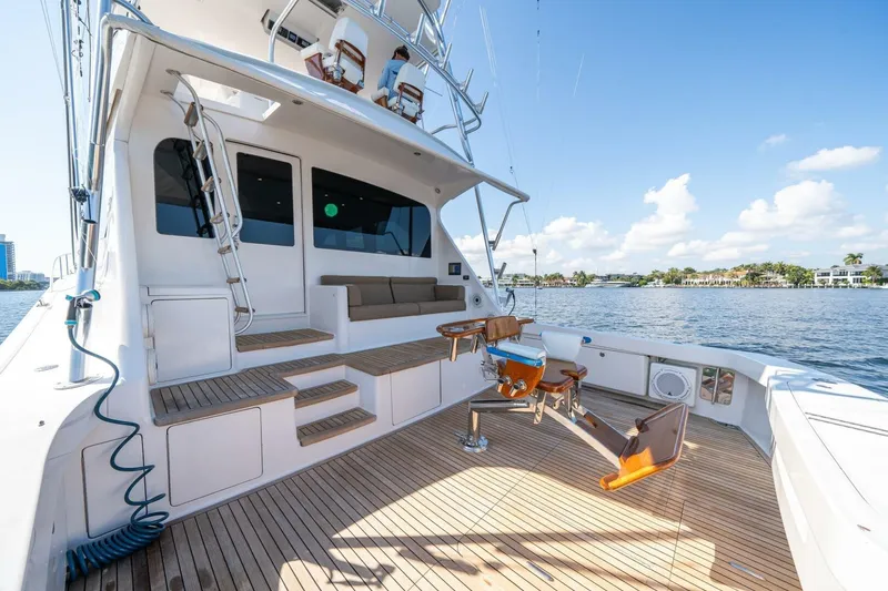 Slide: The Image of 2006 Viking 68 Convertible yacht deck with fishing chair, overlooking calm waters. - 3