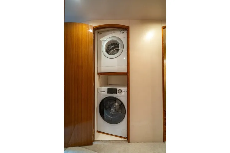 Slide: The Image of Stacked washer and dryer in 2006 Viking 68 Convertible yacht interior. - 30
