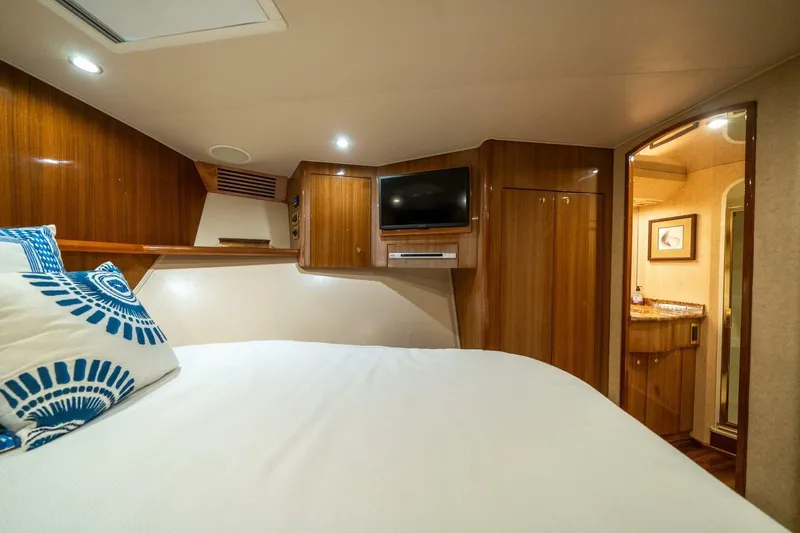 Slide: The Image of Luxurious cabin interior of 2006 Viking 68 Convertible yacht with wood paneling and modern amenities. - 33